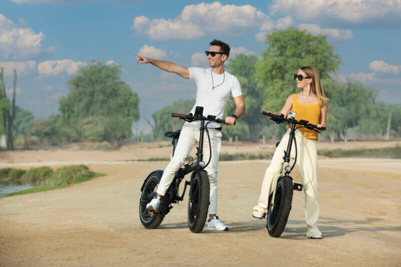 Biyiy Experience - man and woman riding e-bikes in the desert