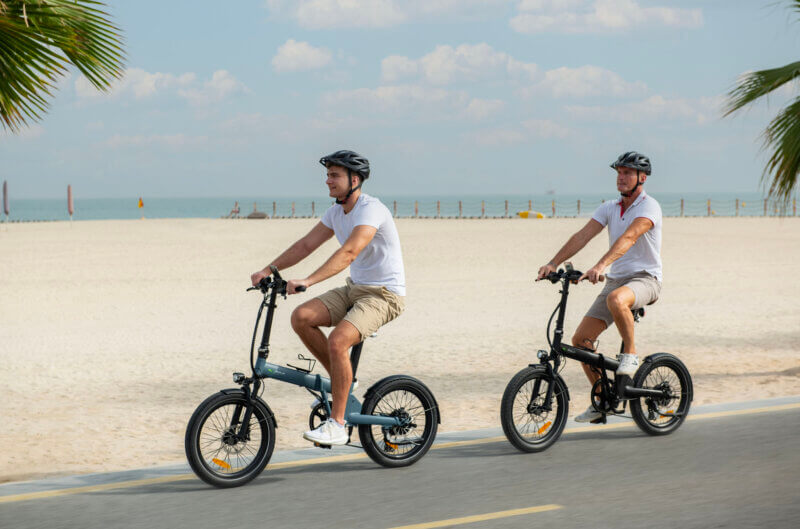 Biyiy Experience - 2 men riding their e-bikes on the beach of Dubai